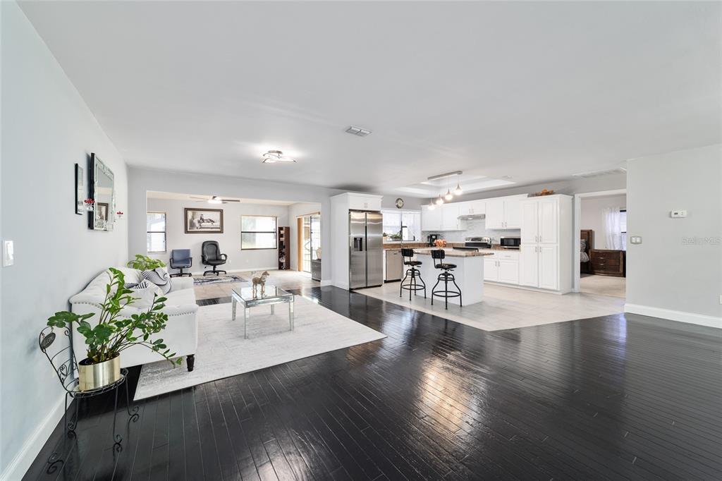 985 Northwest 73rd Terrace Ocala, FL 34482 - Photo 38 of 89 a living room with furniture and a wooden floor