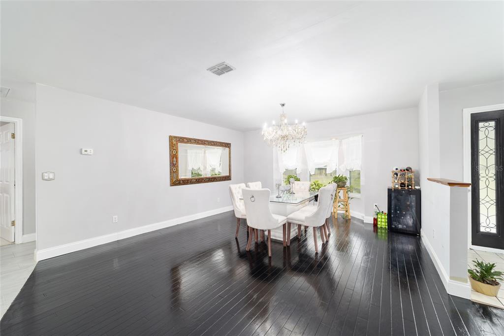 985 Northwest 73rd Terrace Ocala, FL 34482 - Photo 39 of 89 a view of a dining room with furniture and wooden floor