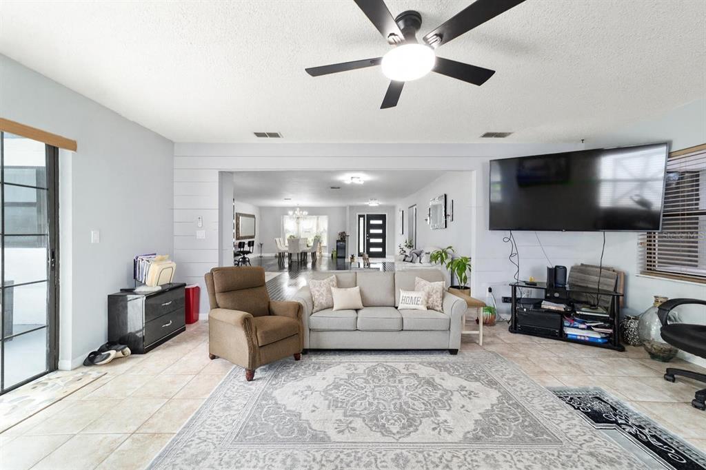 985 Northwest 73rd Terrace Ocala, FL 34482 - Photo 59 of 89 a living room with furniture and a flat screen tv