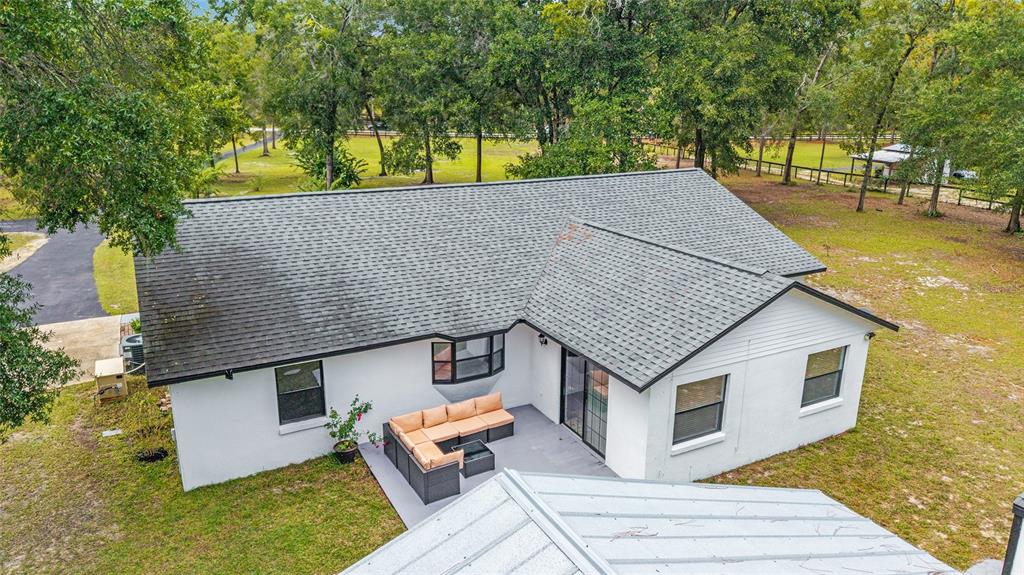 985 Northwest 73rd Terrace Ocala, FL 34482 - Photo 83 of 89 a aerial view of a house with a yard and trees