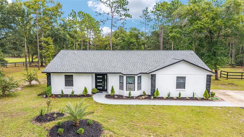 985 Northwest 73rd Terrace Ocala, FL 34482 - Photo 89 of 89 a front view of house with swimming pool and green space