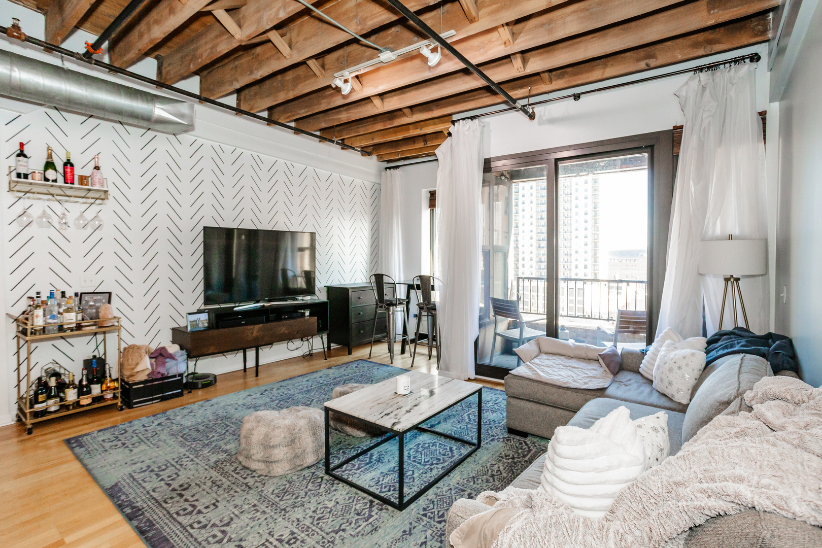 1503 South State Street, Unit 810 Chicago, IL 60605 - Photo 6 of 16 a living room with furniture and a flat screen tv