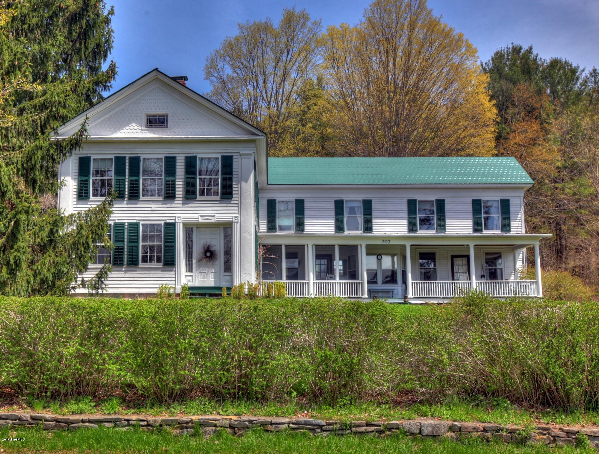 207 Main Road Tyringham, MA 01264 - Photo 17 of 71 a front view of a house with a yard table and chairs