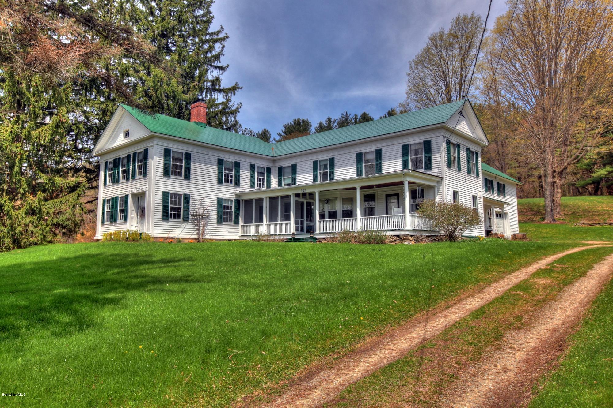 207 Main Road Tyringham, MA 01264 - Photo 3 of 71 a front view of a house with a garden