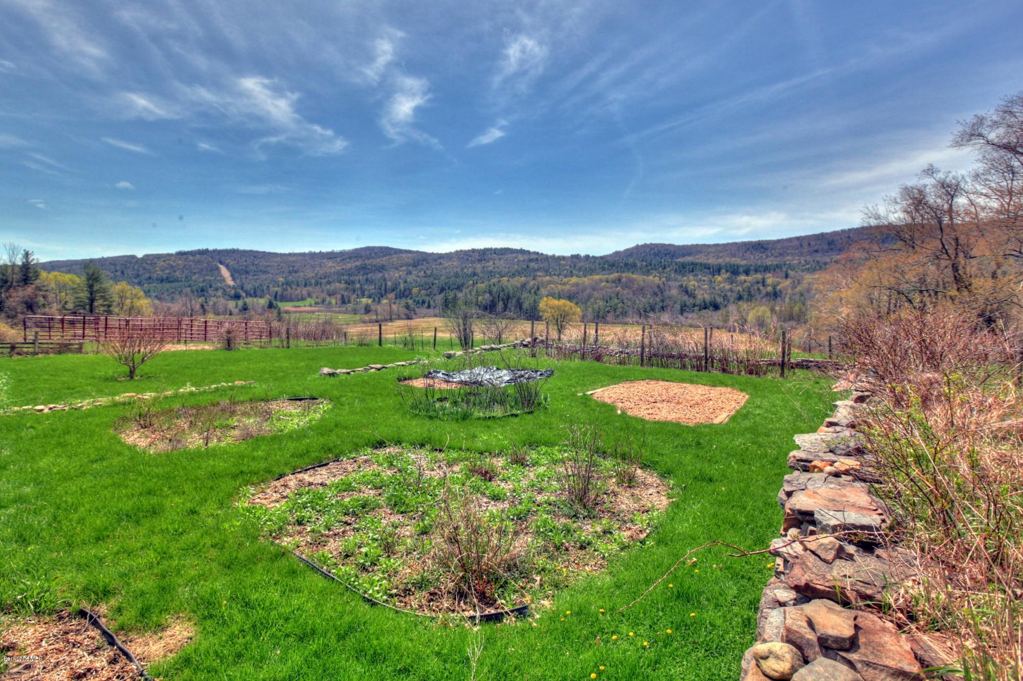 207 Main Road Tyringham, MA 01264 - Photo 23 of 71 a view of a garden with mountains in the background
