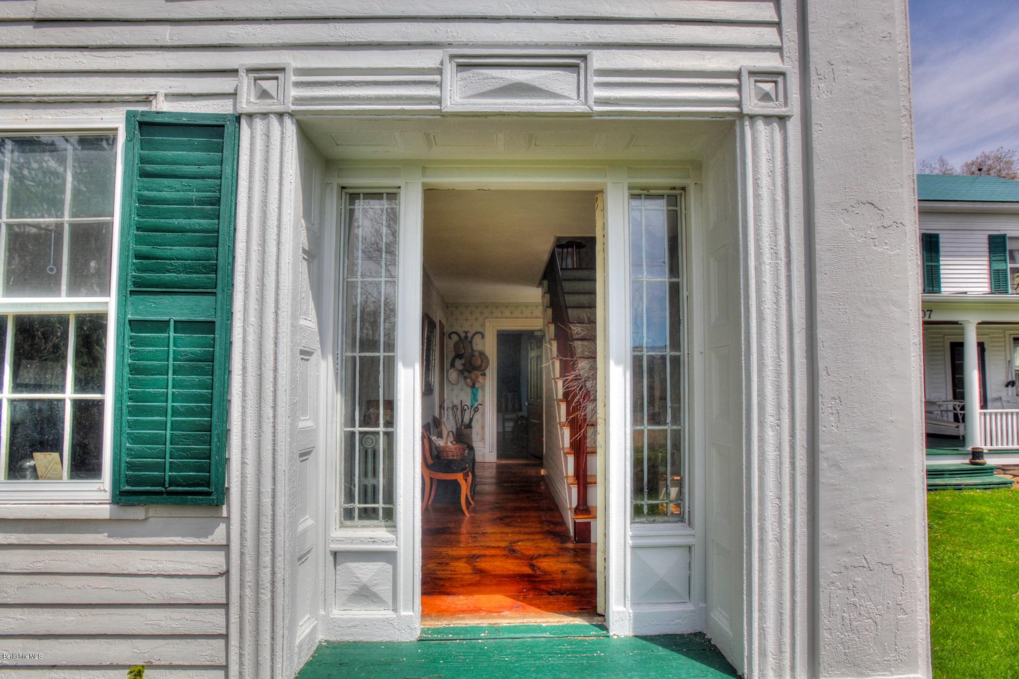 207 Main Road Tyringham, MA 01264 - Photo 35 of 71 a view of a porch with a door and a yard
