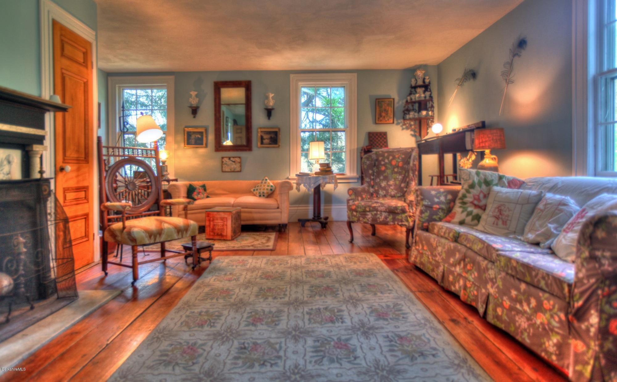 207 Main Road Tyringham, MA 01264 - Photo 40 of 71 a living room with furniture and a chandelier