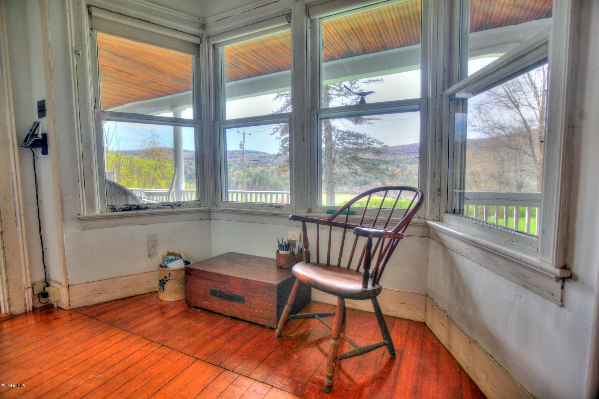 207 Main Road Tyringham, MA 01264 - Photo 47 of 71 a living room with furniture and a floor to ceiling window