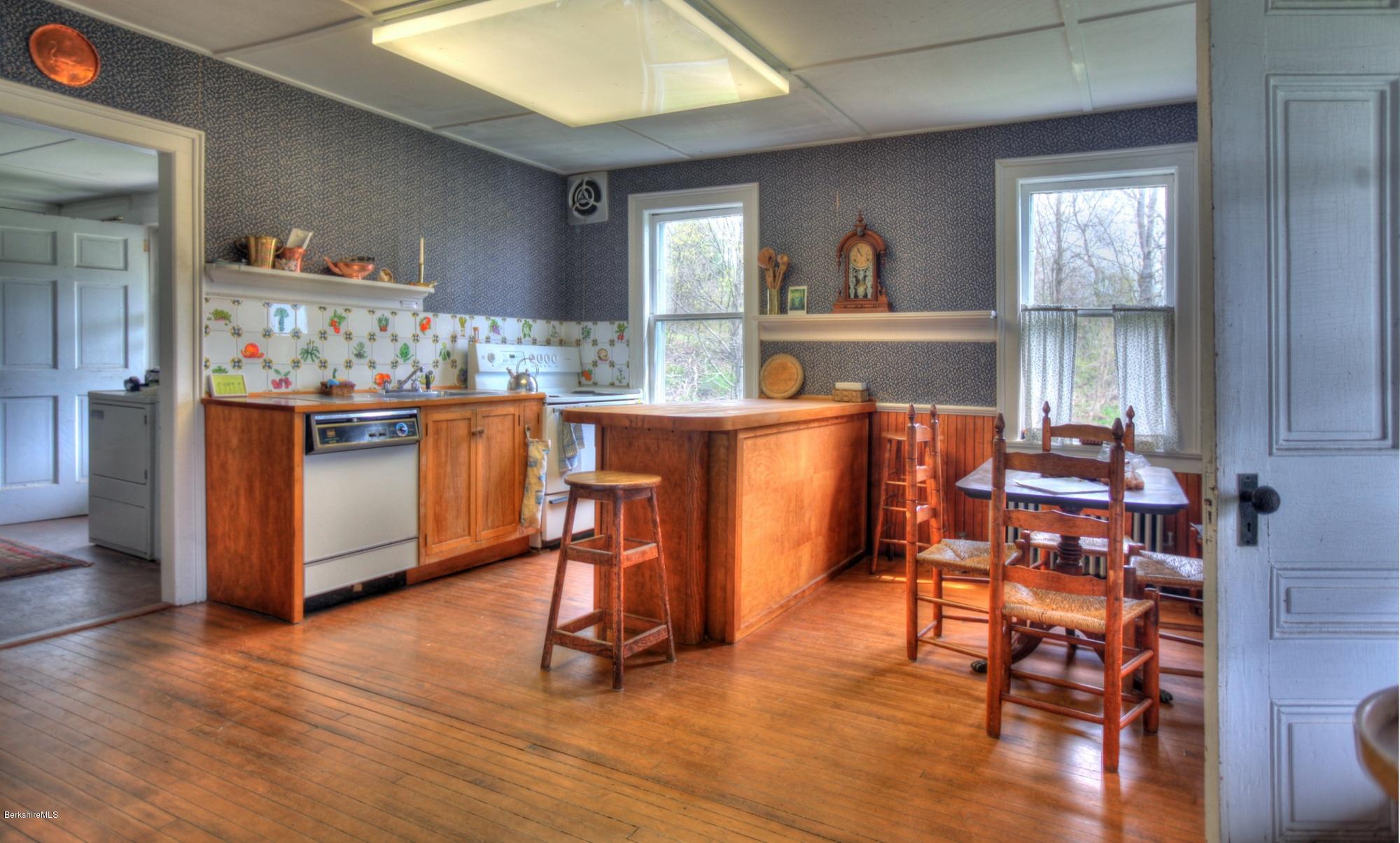 207 Main Road Tyringham, MA 01264 - Photo 48 of 71 a view of a dining room with furniture and wooden floor