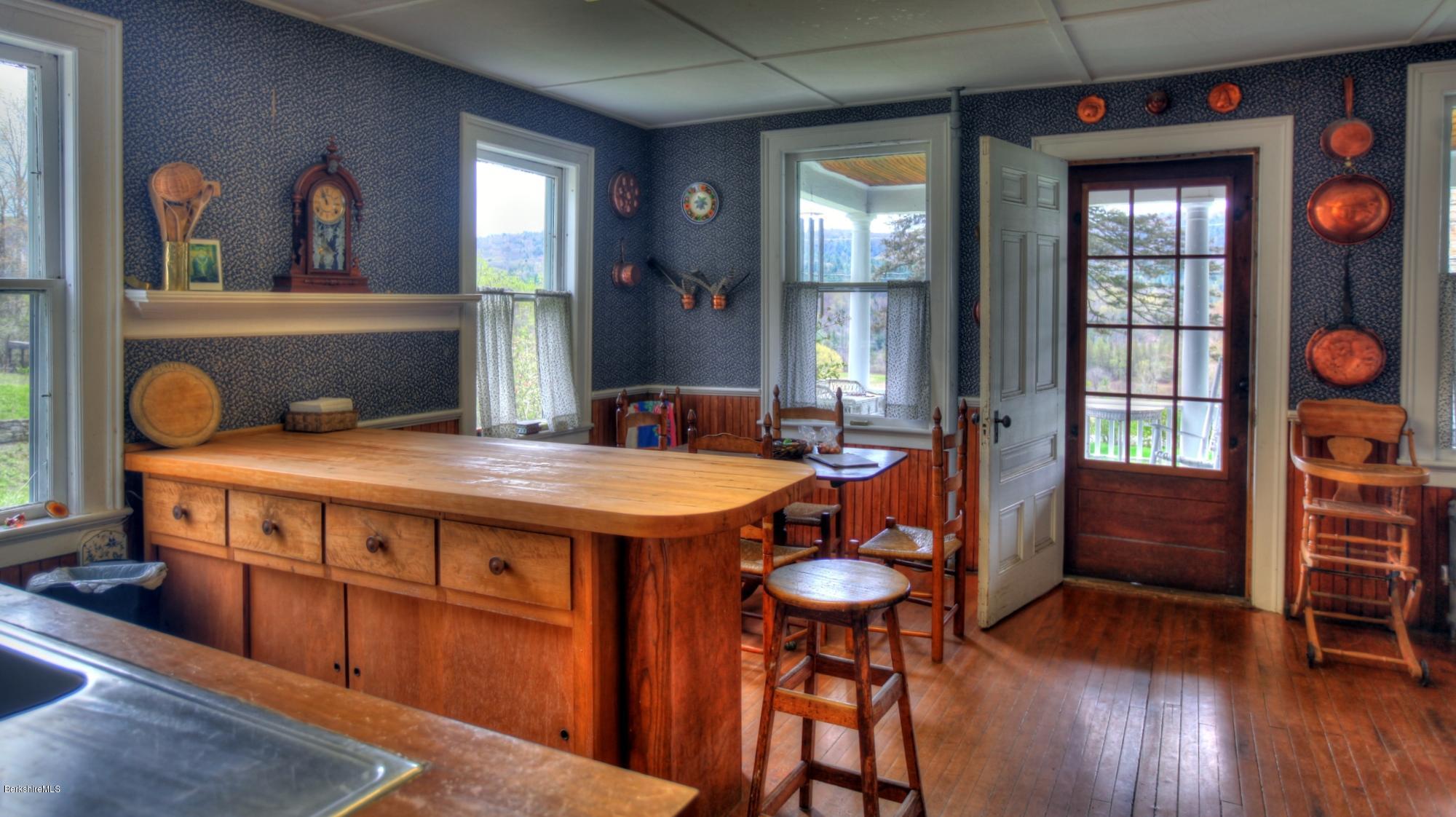 207 Main Road Tyringham, MA 01264 - Photo 49 of 71 a dining room with furniture a chandelier and wooden floor