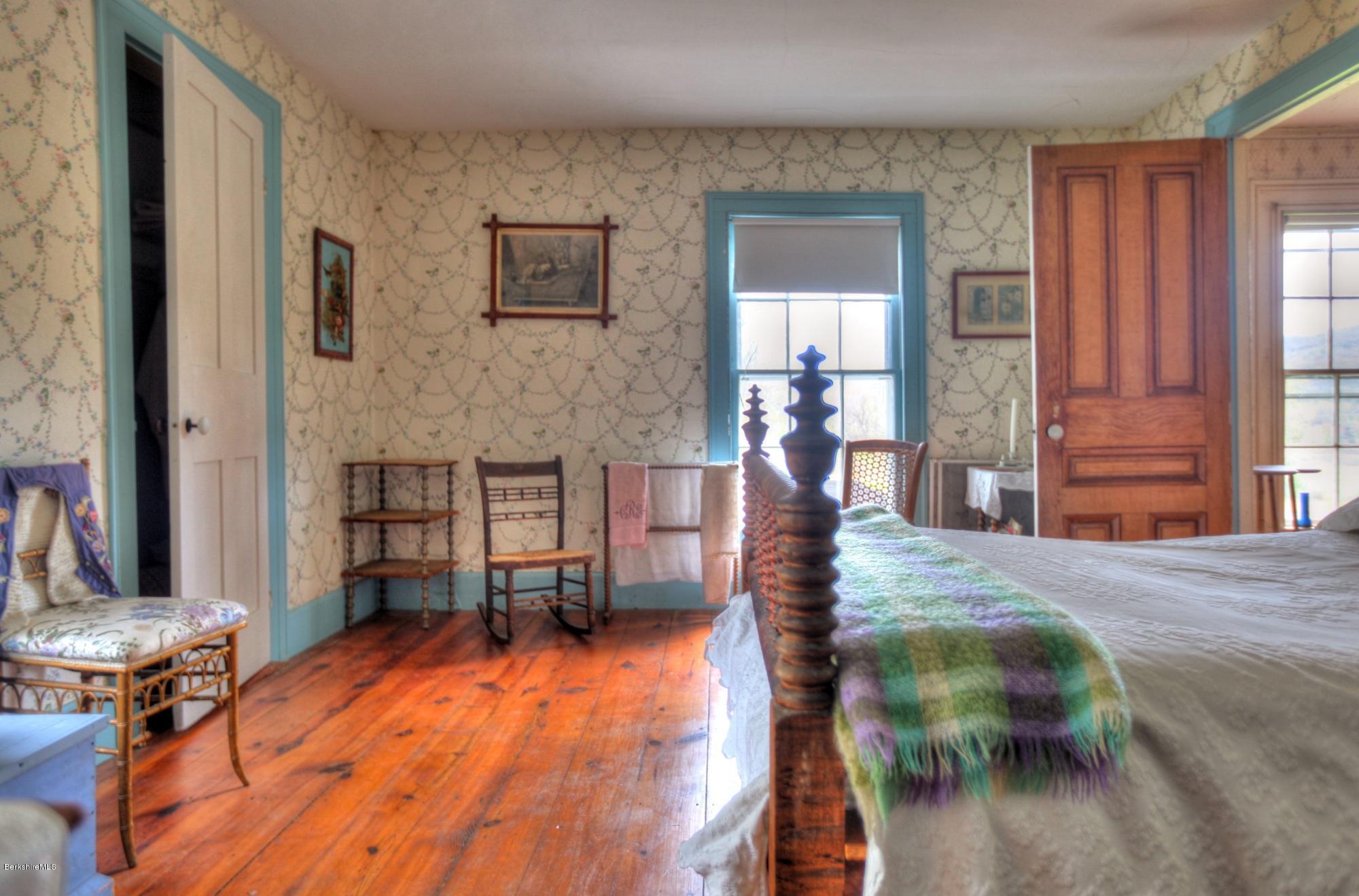 207 Main Road Tyringham, MA 01264 - Photo 54 of 71 a bedroom with furniture and a wooden floor