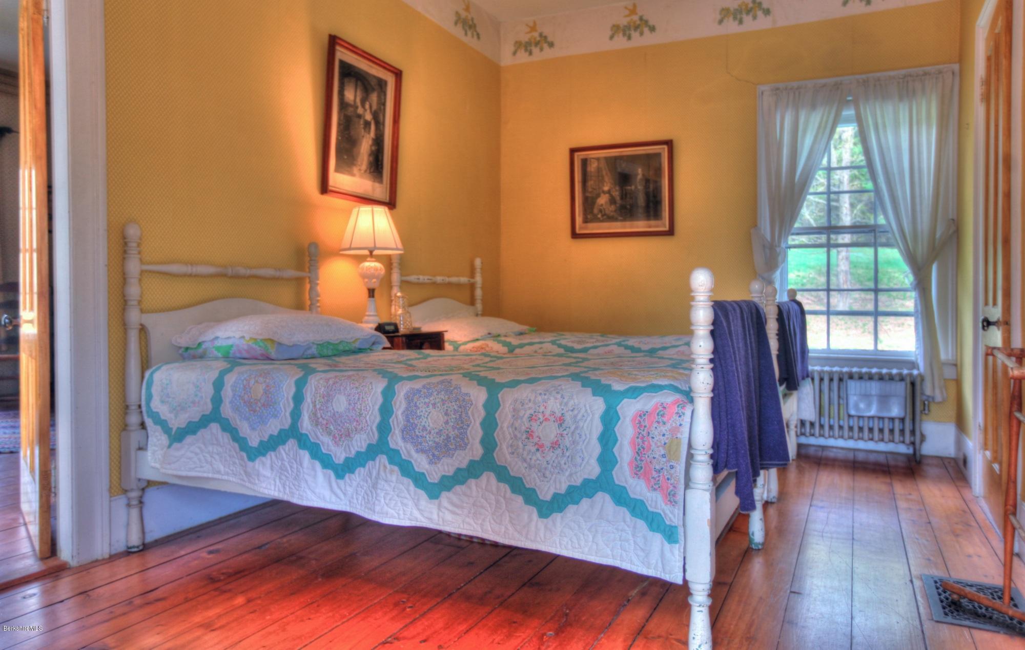 207 Main Road Tyringham, MA 01264 - Photo 57 of 71 a bed sitting in a bedroom next to a window