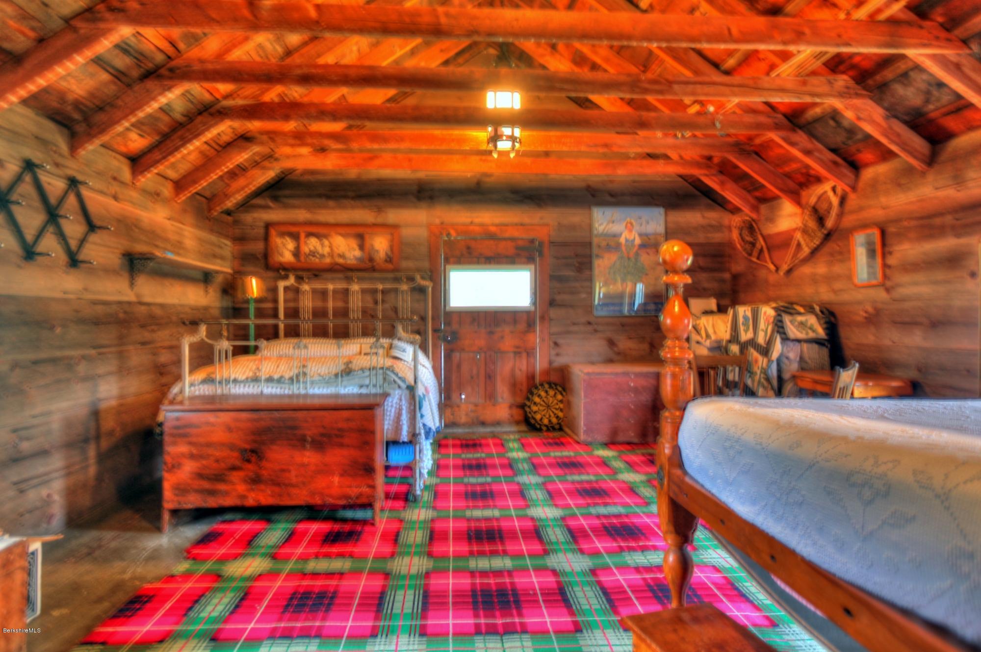 207 Main Road Tyringham, MA 01264 - Photo 65 of 71 a bedroom with a bed and a lamp with the view of city