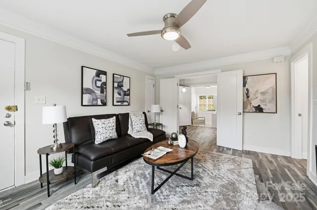 a living room with furniture a rug and a window