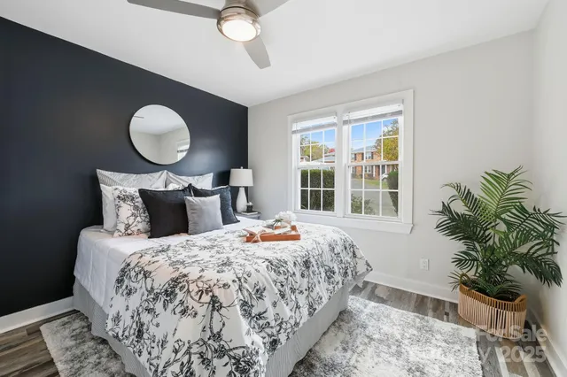 a bedroom with bed and wooden floor