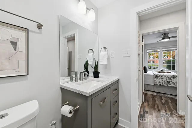 a bathroom with a sink a toilet and mirror