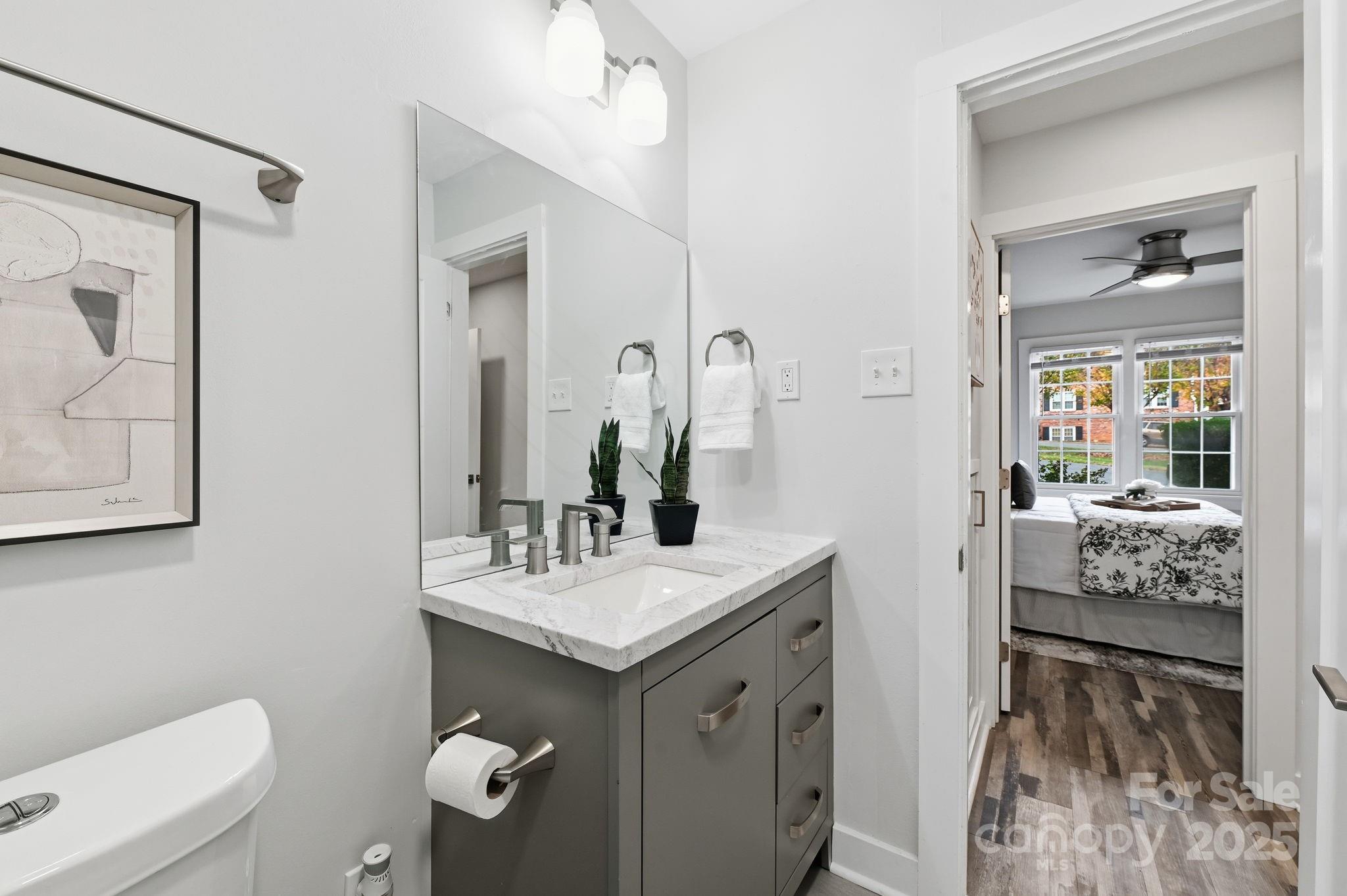 912 McAlway Road, Unit A Charlotte, NC 28211 - Photo 23 of 33 a bathroom with a sink a toilet and mirror