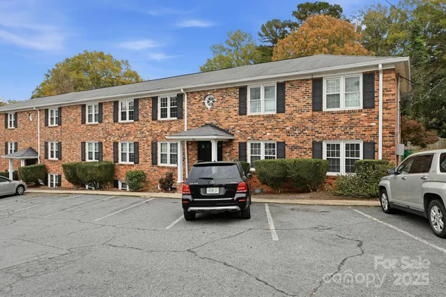 a car parked in front of a white house