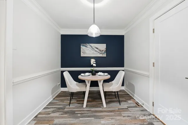 a view of a dining room with a table and chairs