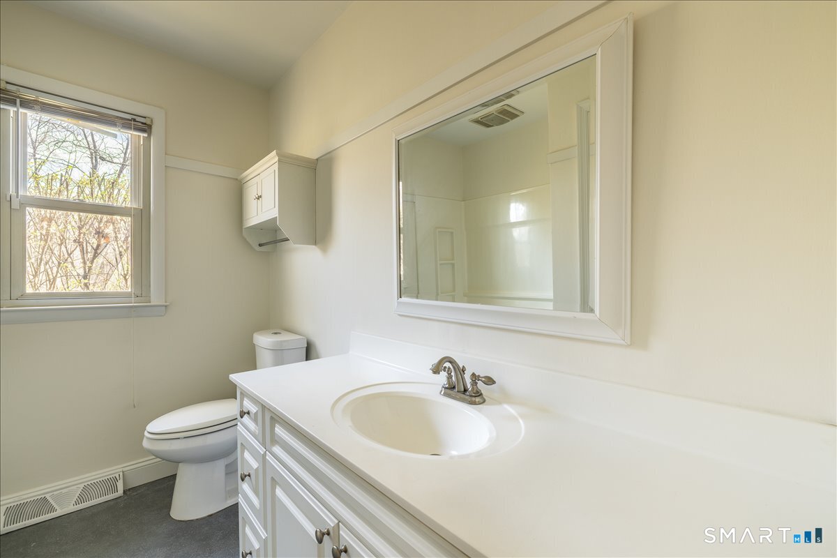 370 Quaker Farms Road Southbury, CT 06488 - Photo 15 of 35 a bathroom with a toilet sink vanity granite and mirror