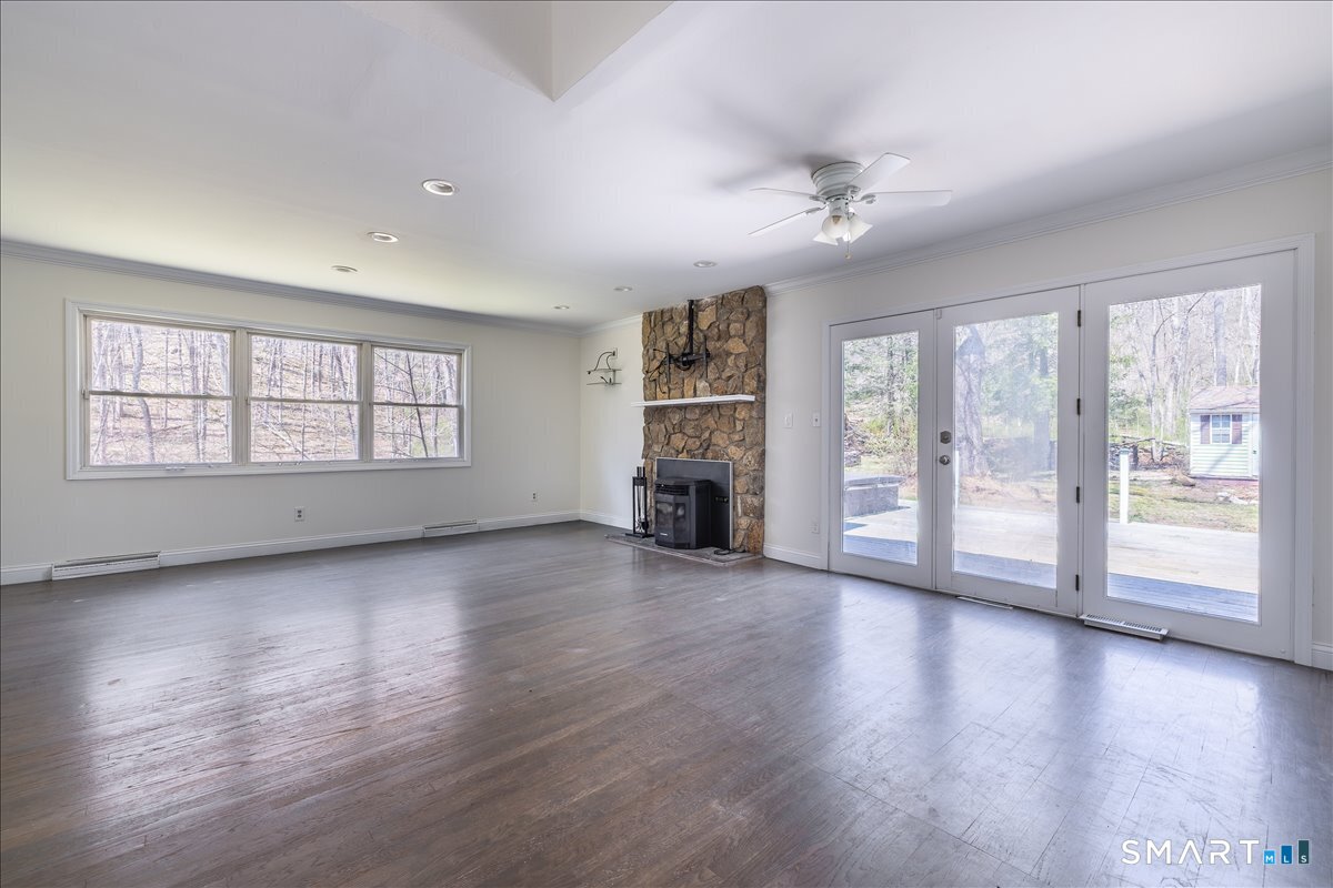 370 Quaker Farms Road Southbury, CT 06488 - Photo 2 of 35 a view of an empty room with a window and wooden floor