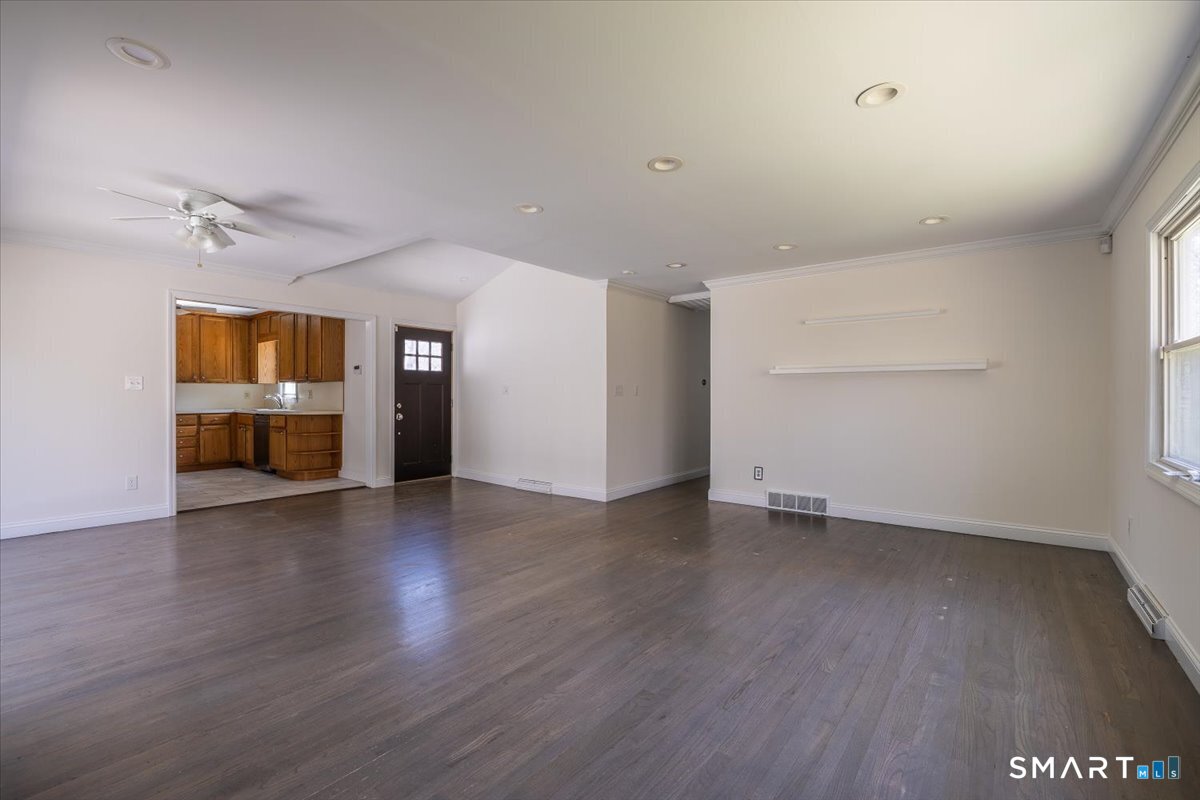 370 Quaker Farms Road Southbury, CT 06488 - Photo 6 of 35 an empty room with wooden floor and windows