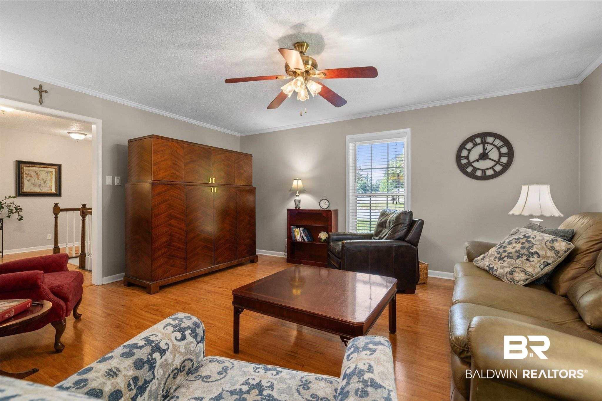706 Sutherland Drive Chickasaw, AL 36611 - Photo 9 of 33 Living room featuring light wood-type flooring, baseboards, ornamental molding, and ceiling fan
