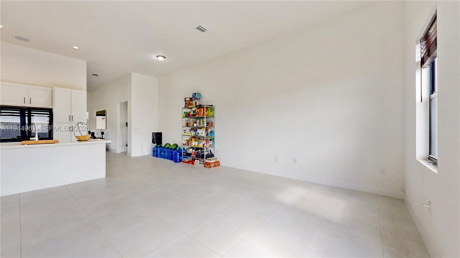 31171 Southwest 193rd Avenue Homestead, FL 33030 - Photo 13 of 36 an empty room with furniture and a flat screen tv