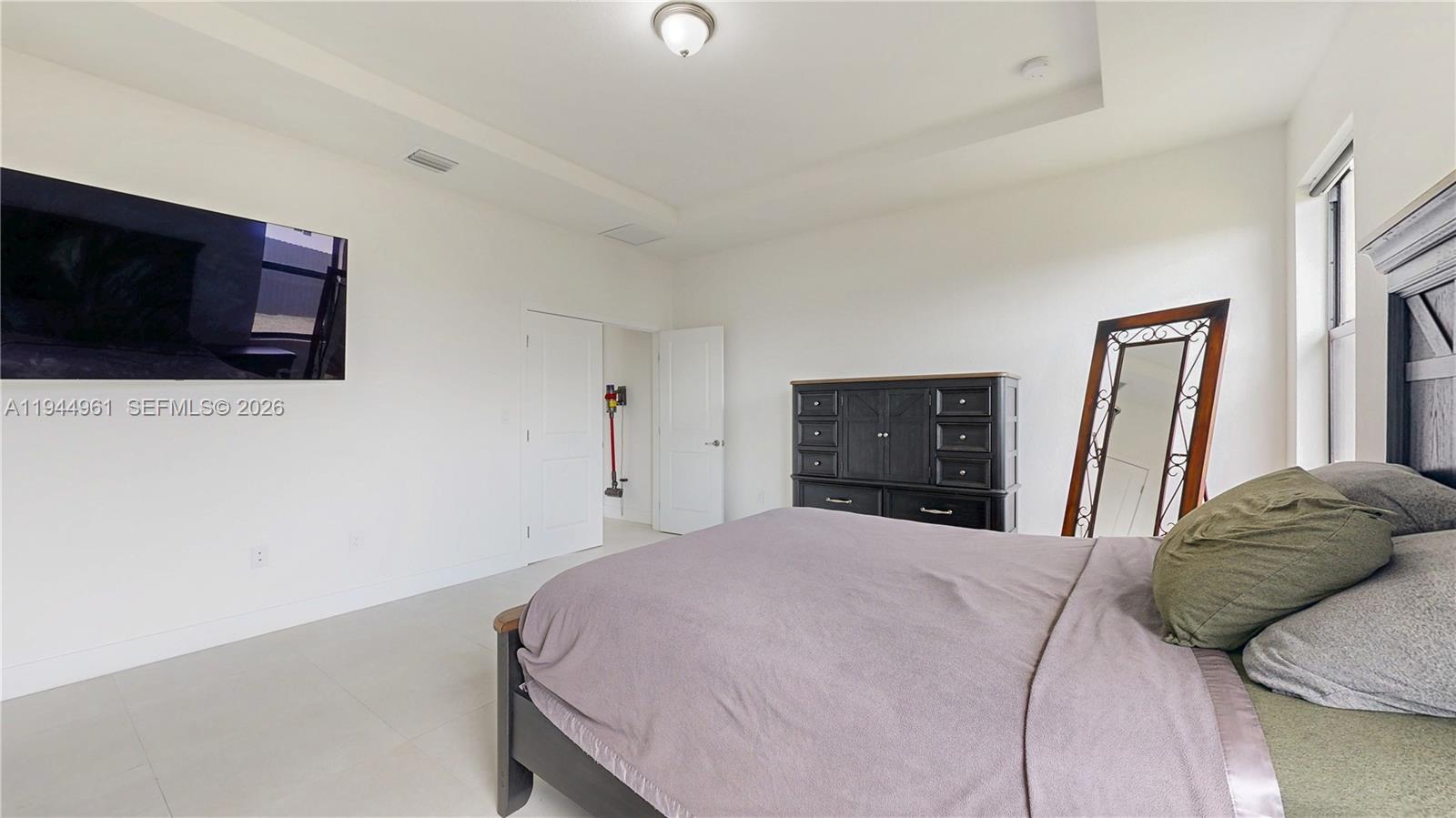 31171 Southwest 193rd Avenue Homestead, FL 33030 - Photo 15 of 36 a bedroom with a bed and a flat screen tv