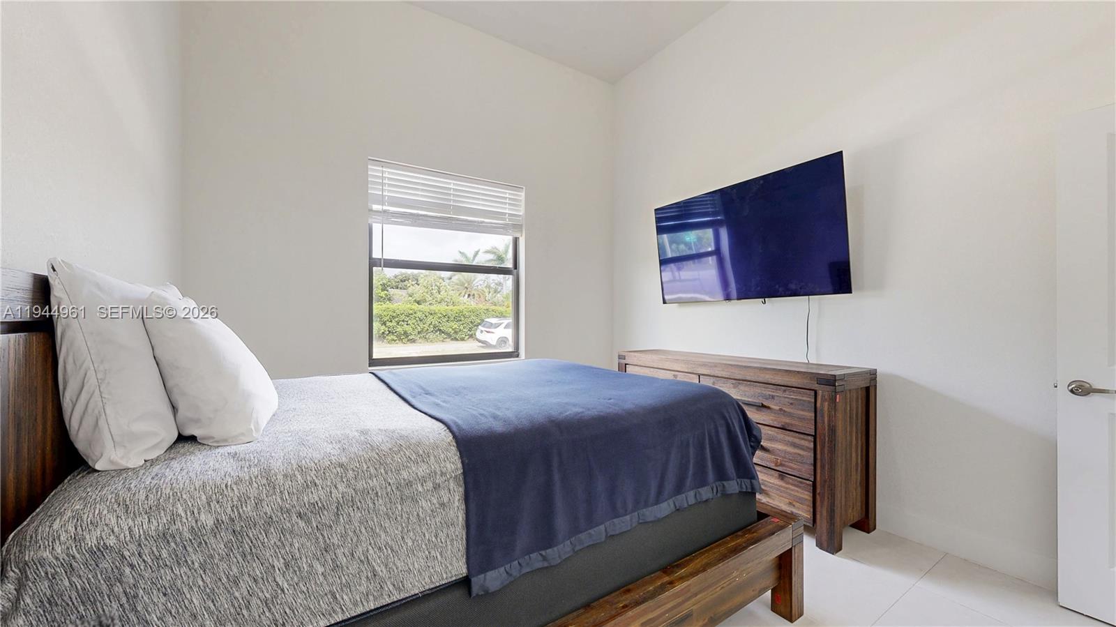 31171 Southwest 193rd Avenue Homestead, FL 33030 - Photo 19 of 36 a bedroom with a bed and wooden floor