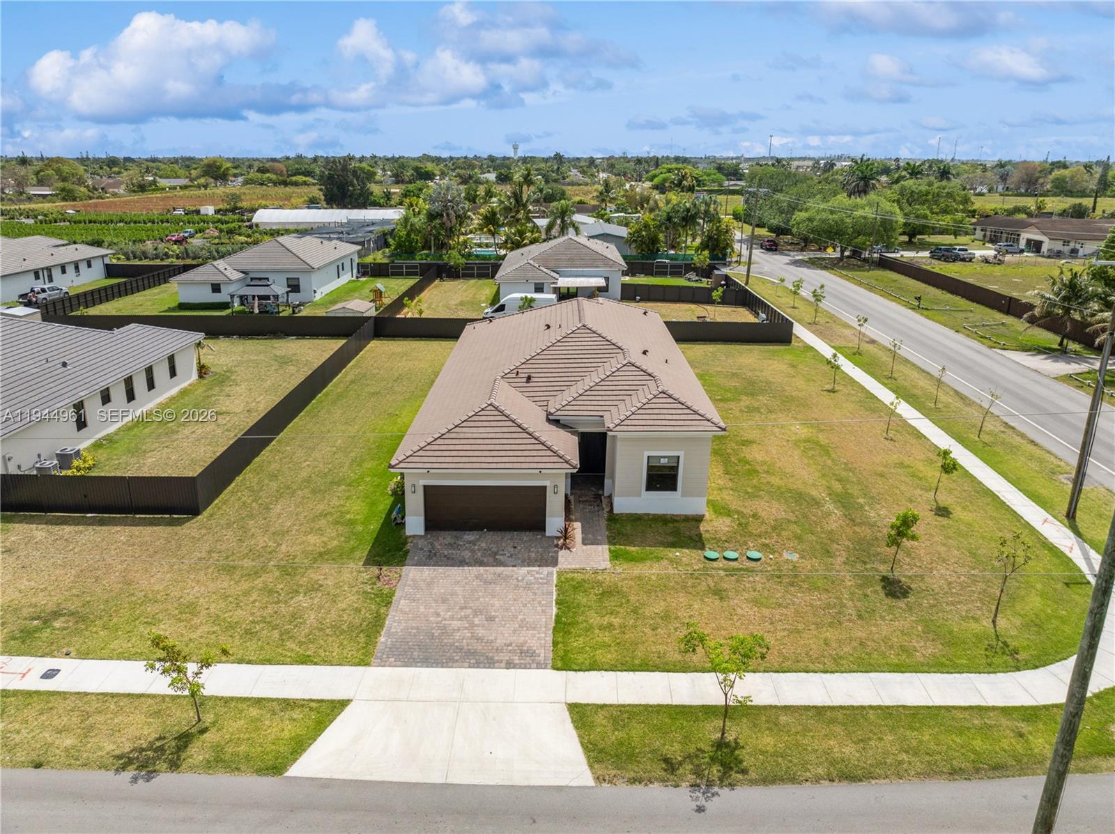 31171 Southwest 193rd Avenue Homestead, FL 33030 - Photo 2 of 36 a view of a swimming pool with an outdoor seating