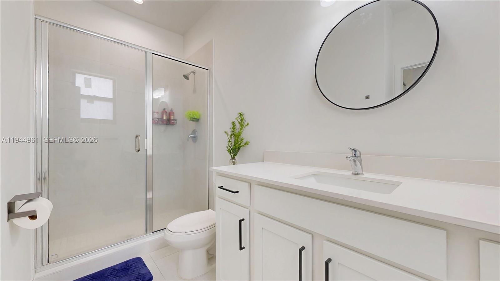 31171 Southwest 193rd Avenue Homestead, FL 33030 - Photo 21 of 36 a bathroom with a sink a toilet and a mirror