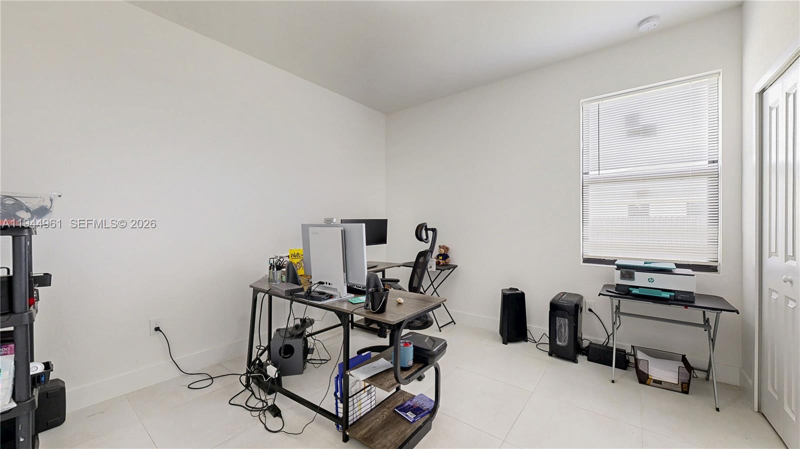 31171 Southwest 193rd Avenue Homestead, FL 33030 - Photo 24 of 36 a room with gym equipment and a window