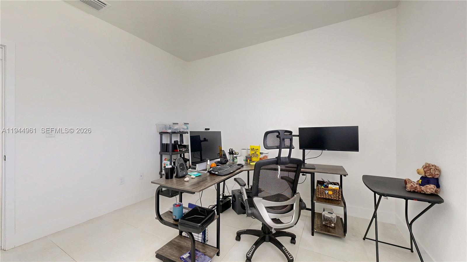 31171 Southwest 193rd Avenue Homestead, FL 33030 - Photo 25 of 36 a view of a workspace with furniture and a window