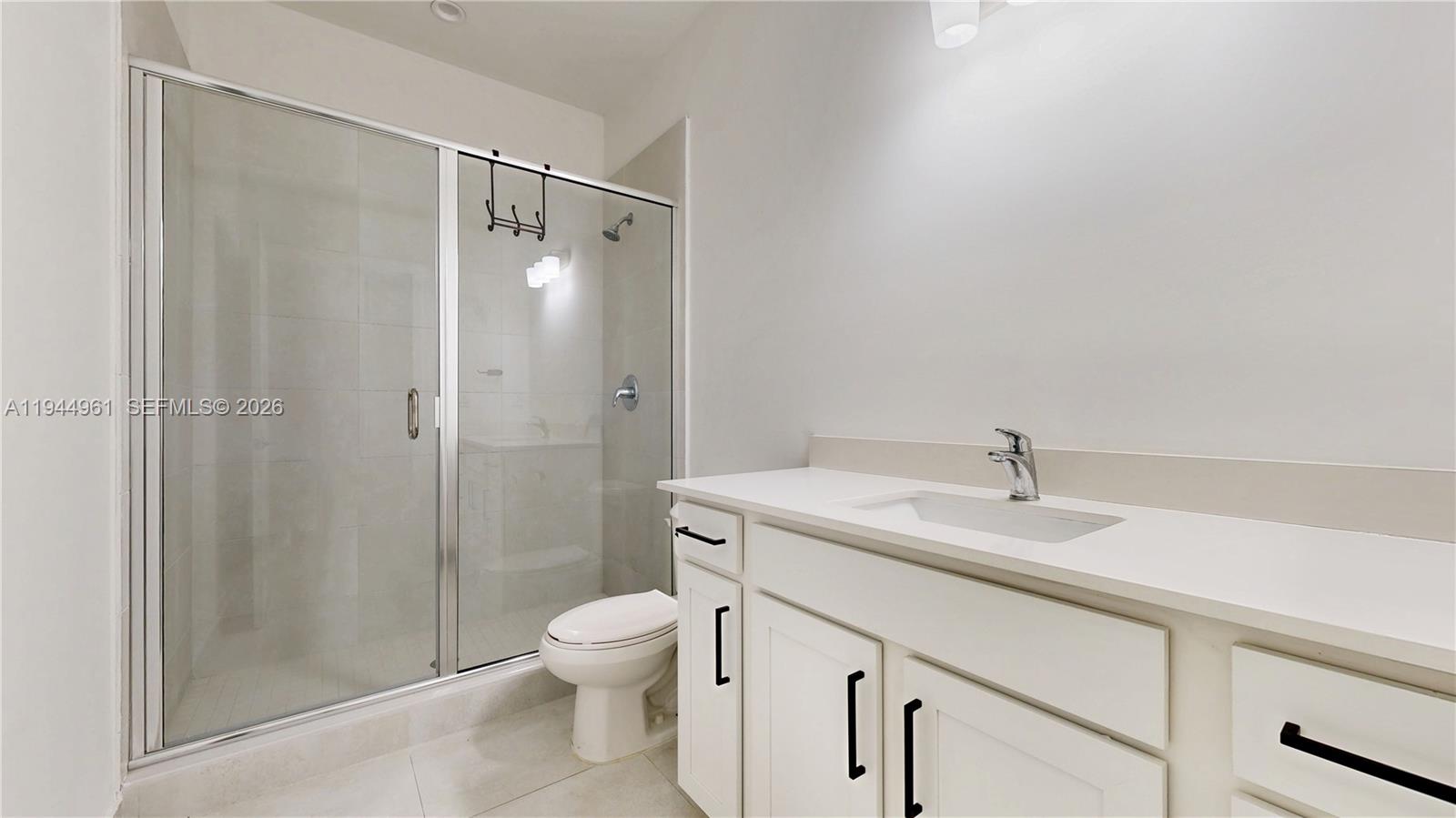 31171 Southwest 193rd Avenue Homestead, FL 33030 - Photo 26 of 36 a bathroom with a granite countertop sink toilet and shower
