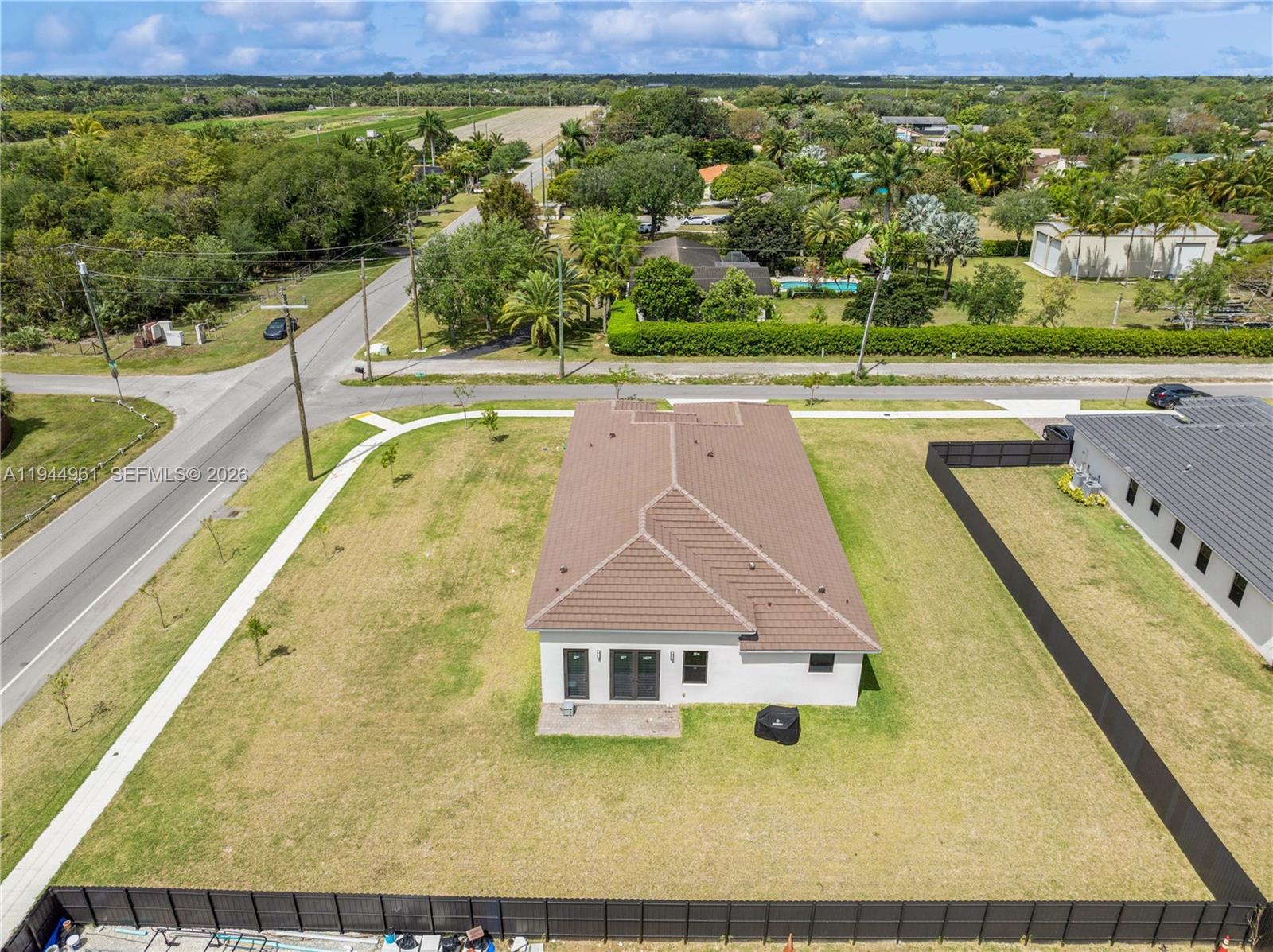 31171 Southwest 193rd Avenue Homestead, FL 33030 - Photo 33 of 36 a view of a swimming pool with an outdoor seating