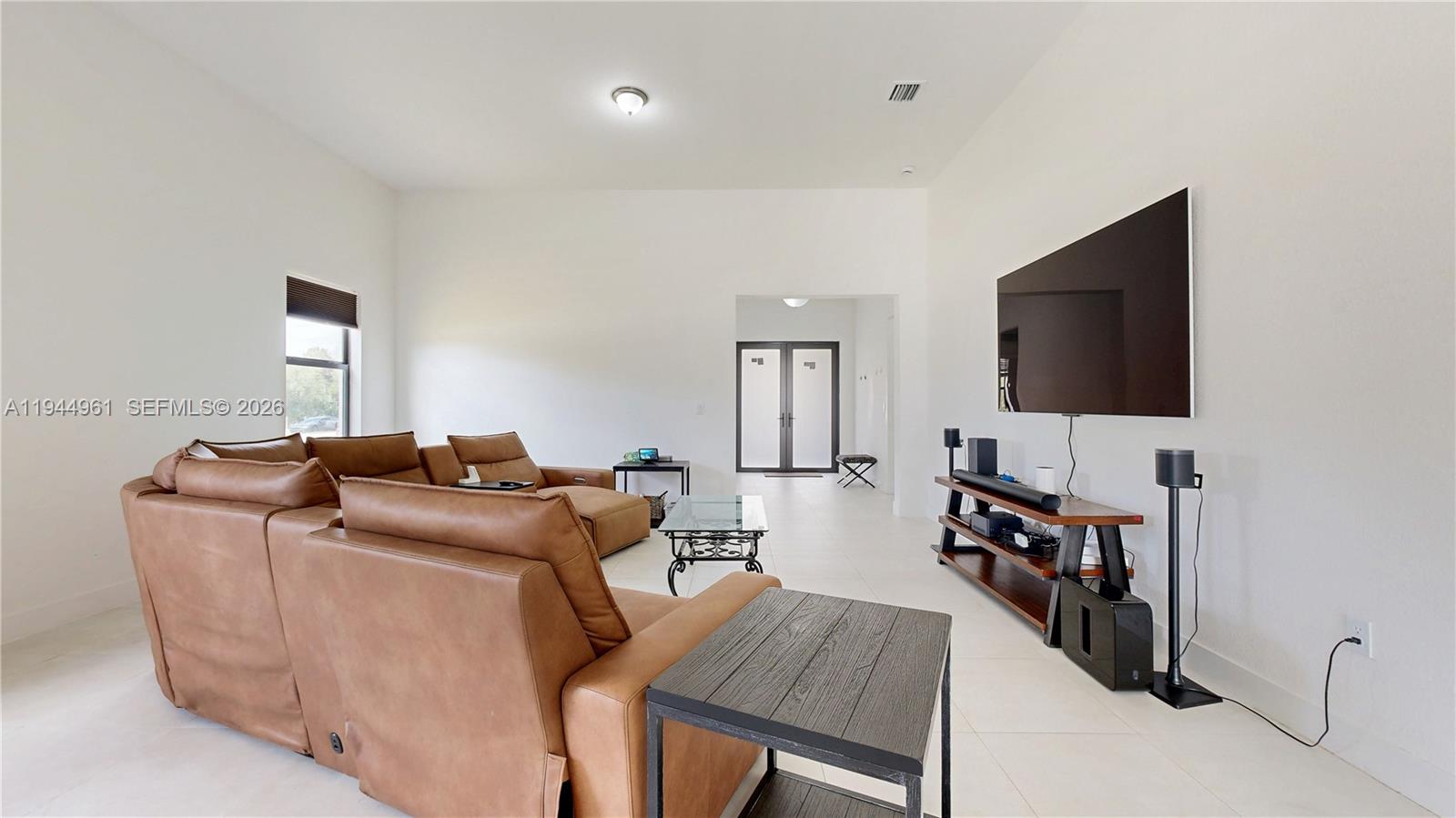 31171 Southwest 193rd Avenue Homestead, FL 33030 - Photo 7 of 36 a living room with furniture and a flat screen tv