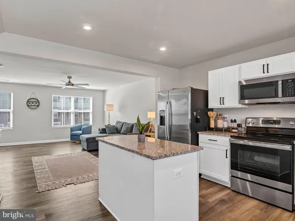 a kitchen with sink refrigerator and microwave