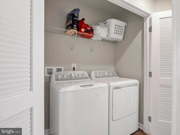 a view of storage and utility room with washer and dryer