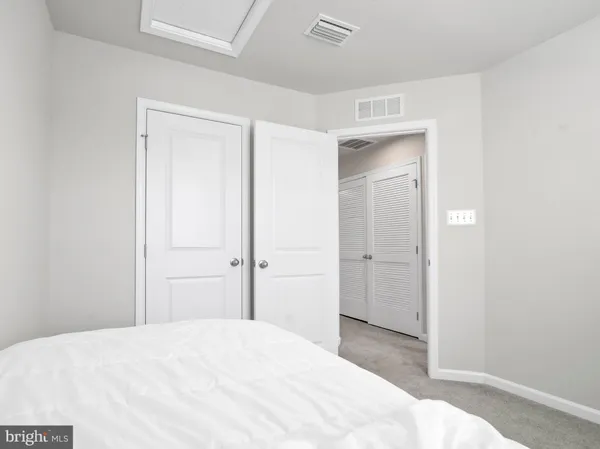 a bedroom with a bed and closet
