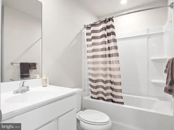 a bathroom with a sink a toilet and a bathtub