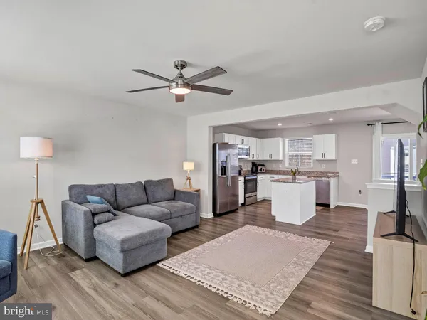 a living room with furniture and kitchen view