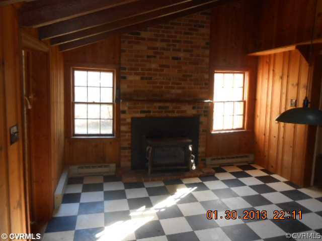 262 Stage Junction Road Columbia, VA 23038 - Photo 2 of 10 a living room with a rug and a fireplace