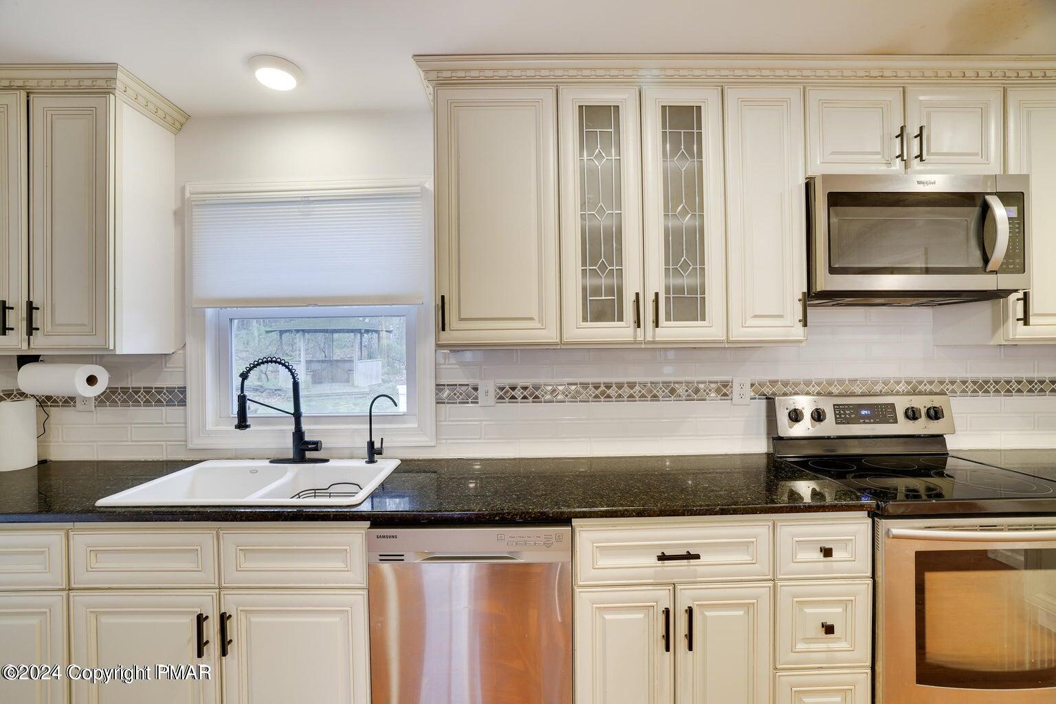 755 White Oak Road Cresco, PA 18326 - Photo 9 of 50 a kitchen with stainless steel appliances granite countertop a sink a stove and cabinets