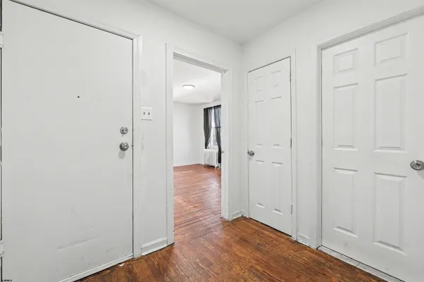 a view of a room with wooden floor and windows
