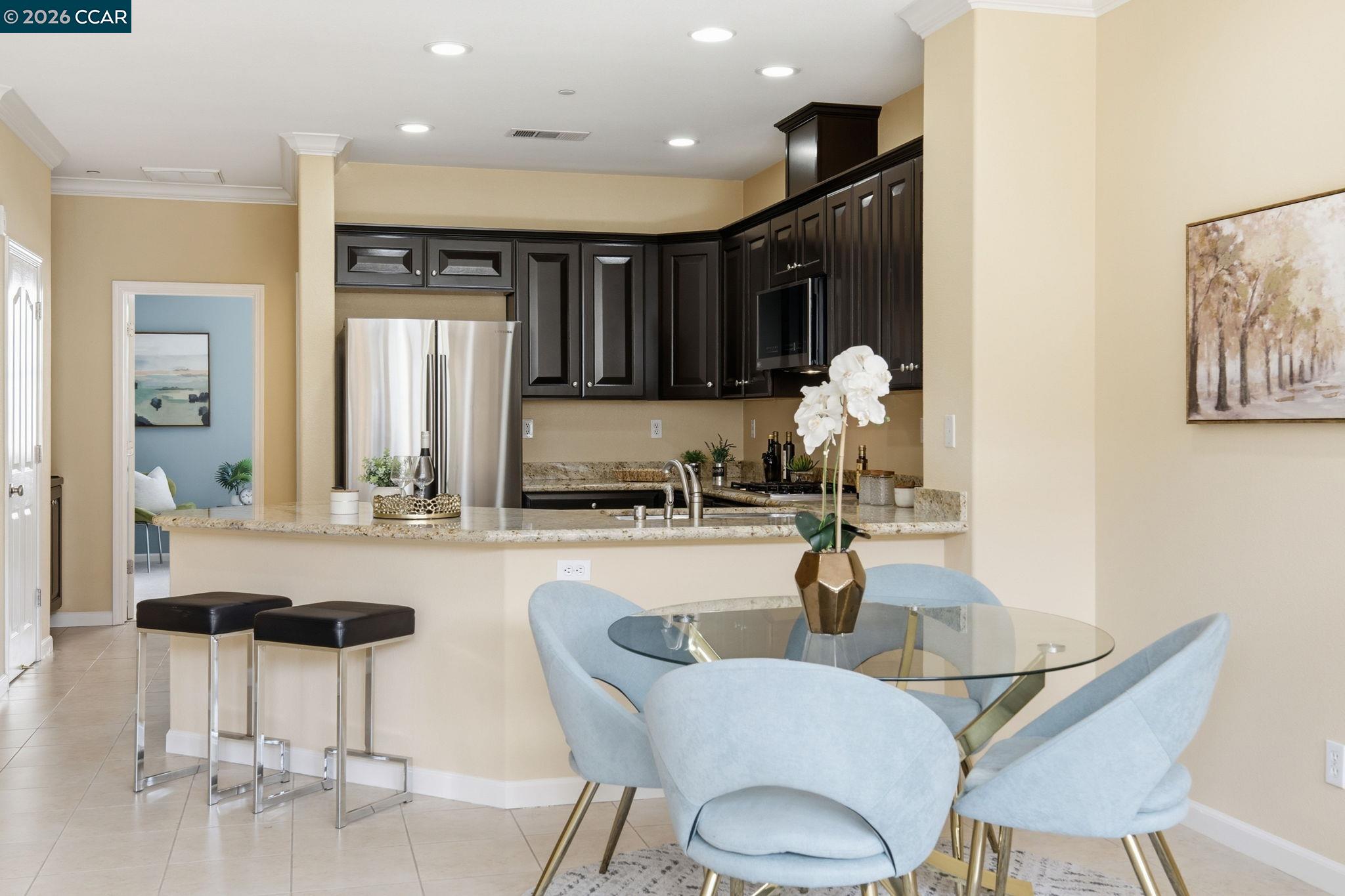 252 Sullivan Way Hayward, CA 94541 - Photo 16 of 55 a kitchen with granite countertop a table and chairs