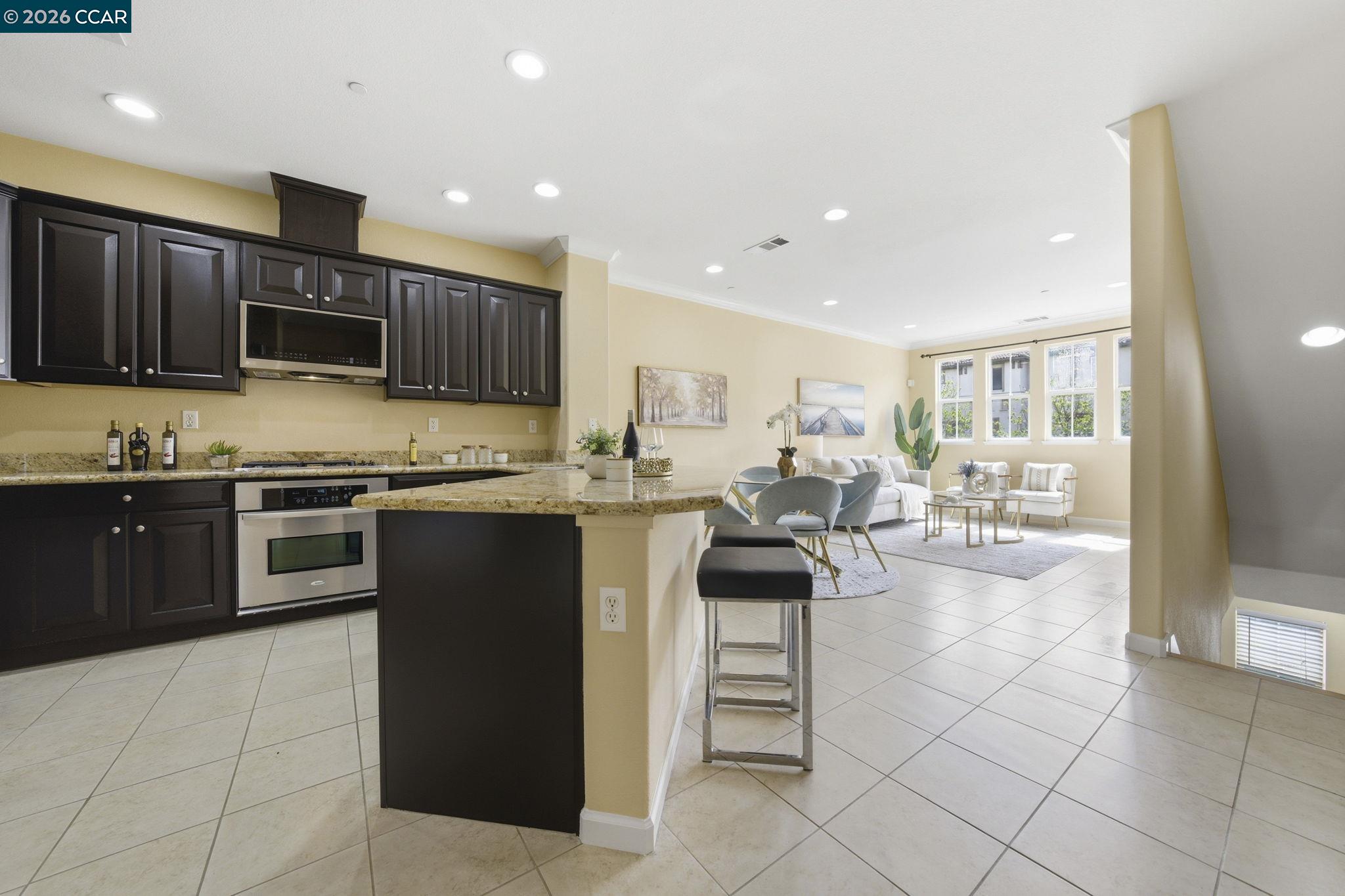 252 Sullivan Way Hayward, CA 94541 - Photo 19 of 55 a kitchen with stainless steel appliances kitchen island granite countertop a stove and cabinets