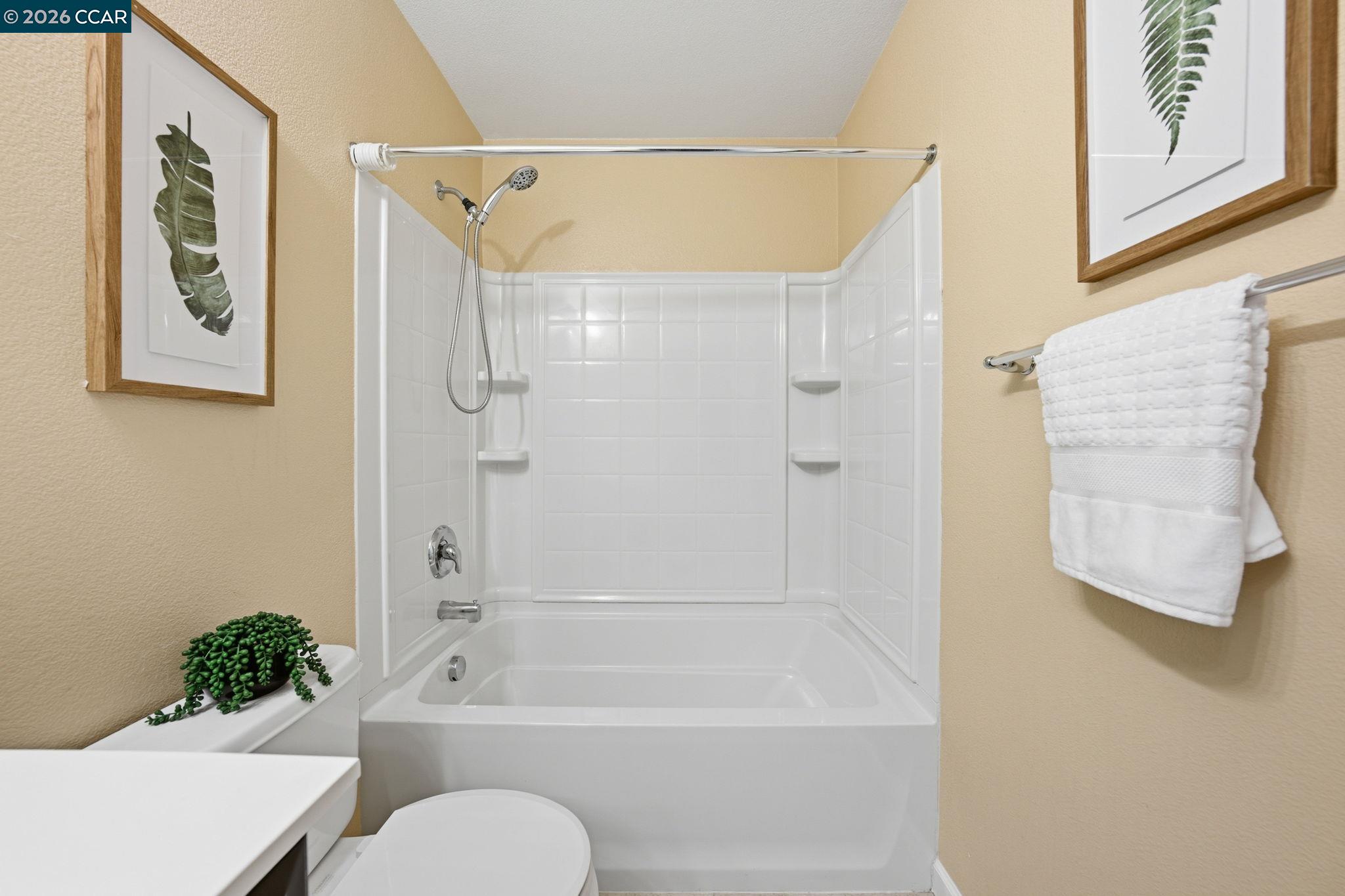 252 Sullivan Way Hayward, CA 94541 - Photo 37 of 55 a bathroom with a shower curtain and a bath tub