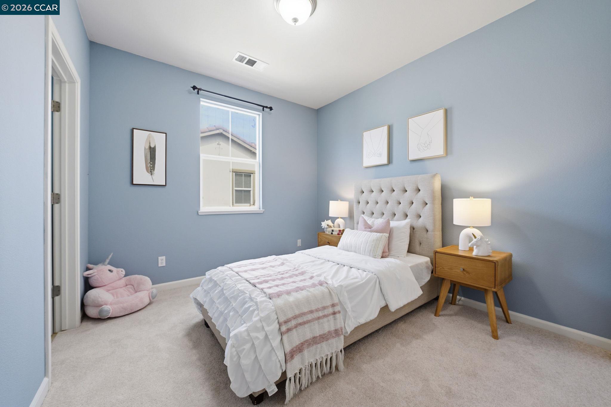 252 Sullivan Way Hayward, CA 94541 - Photo 38 of 55 a bedroom with a bed and lamp