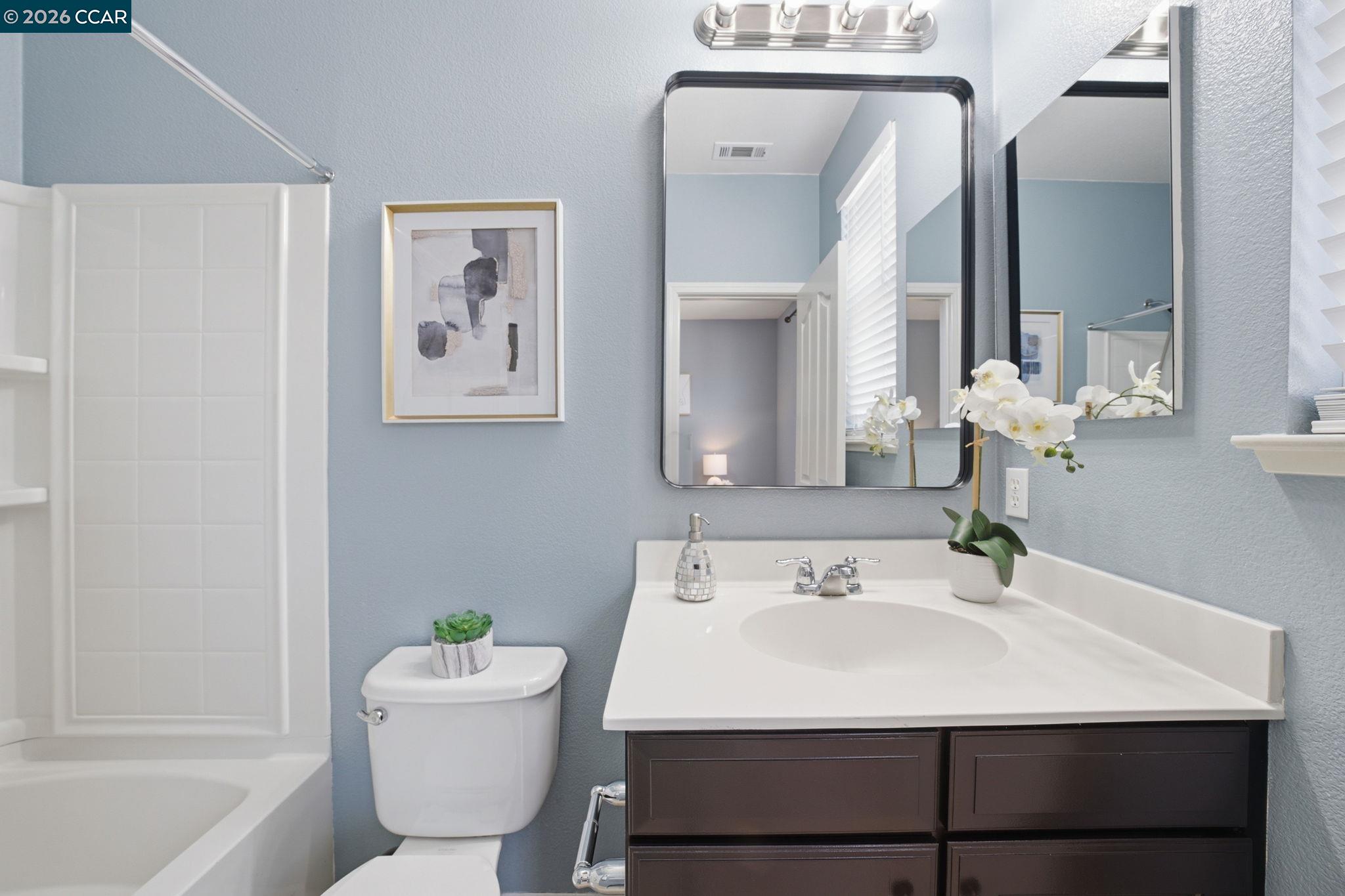 252 Sullivan Way Hayward, CA 94541 - Photo 41 of 55 a bathroom with a sink vanity mirror and toilet